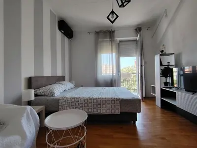 a bedroom with a bed and a table and a tv at Apartman Nataly 2 in Kruševac