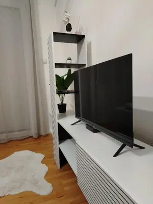 a flat screen tv sitting on a white entertainment center at Apartman Nataly 2 in Kruševac