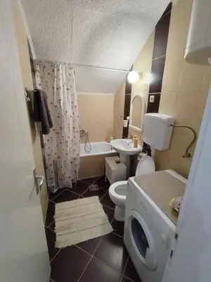 a bathroom with a toilet and a sink and a tub at Apartman Nataly 2 in Kruševac