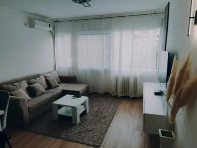 a living room with a couch and a table at Apartman Sale lux in Leskovac