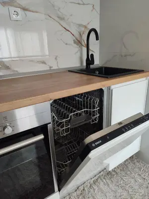 a kitchen with a sink and a dishwasher at Apartman Sale lux in Leskovac
