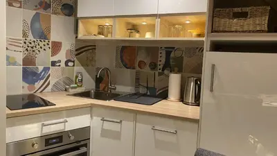 a kitchen with a sink and a refrigerator at Konaci Koznik Porodični in Kopaonik