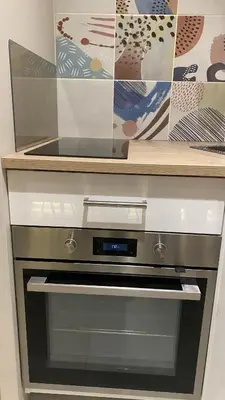 a kitchen with an oven with a counter top at Konaci Koznik Porodični in Kopaonik