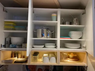 a cupboard filled with plates and dishes at Konaci Koznik Porodični in Kopaonik
