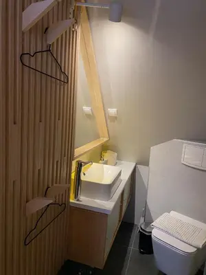 a bathroom with a sink and a mirror and a toilet at Konaci Koznik Porodični in Kopaonik