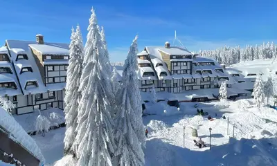 a resort in the snow with snow covered trees at Konaci Koznik Porodični in Kopaonik