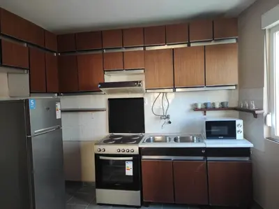 a kitchen with a stove and a refrigerator at Dona Apartments 2 in Niš