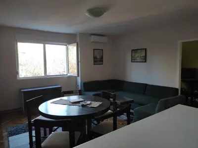 a living room with a couch and a table at Dona Apartments 2 in Niš