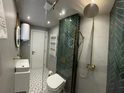 a bathroom with a toilet and a glass shower at Apartmani Central 3 & Free parking garage in Vrnjačka Banja
