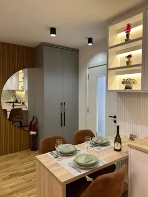 a kitchen and dining room with a table and chairs at Apartmani Central 3 & Free parking garage in Vrnjačka Banja