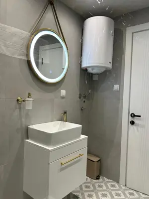 a bathroom with a white sink and a mirror at Apartmani Central 3 & Free parking garage in Vrnjačka Banja