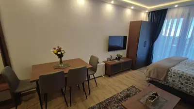 a room with a dining room table and a bedroom at Apartment 12 Kopaonik in Kopaonik