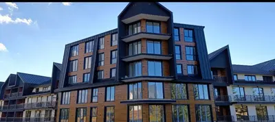 a tall brick building with a black at Apartman 