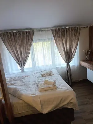 a bedroom with a bed with two towels on it at Apartman 