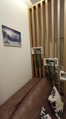 a living room with a brown couch in a room at Apartman 