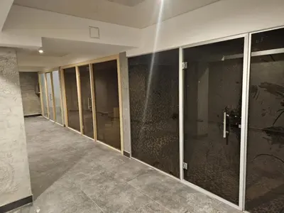 an empty room with glass doors in a building at Apartman 