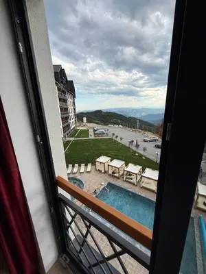 a view of a pool from a window of a hotel at Fashion Residence Hill in Kopaonik