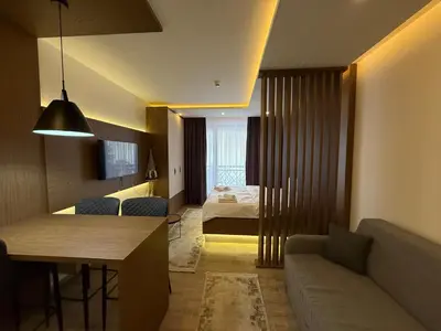 a living room with a couch and a bed at Fashion Residence Hill in Kopaonik