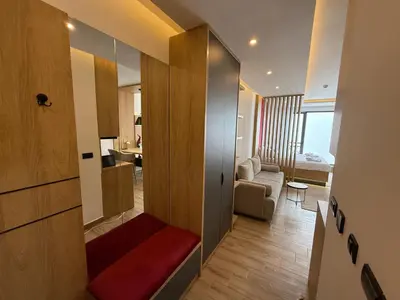 a living room with a red bench in a room at Fashion Residence Hill in Kopaonik