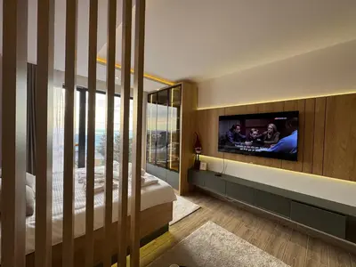 a bedroom with a flat screen tv on a wall at Fashion Residence Hill in Kopaonik