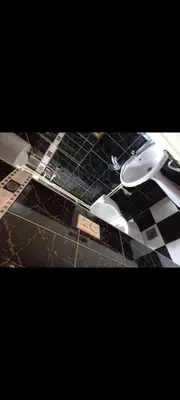 a black and white checkered floor with two toilets at V&Ž-Vb in Vrnjačka Banja