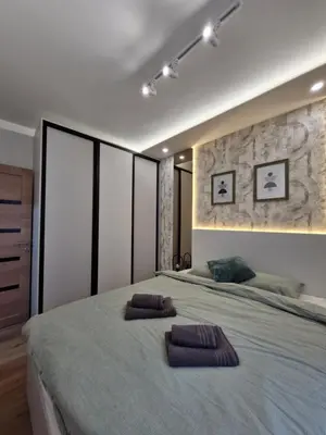a bedroom with a large bed with two pillows on it at VIRTUS apartmani Vrnjačka Banja centar in Vrnjačka Banja