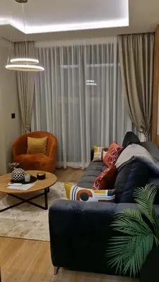 a living room with a couch and a table at VIRTUS apartmani Vrnjačka Banja centar in Vrnjačka Banja