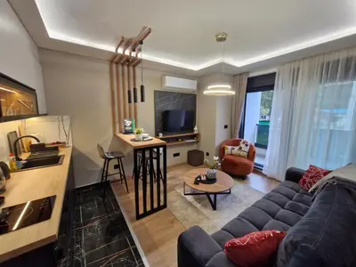 a living room with a couch and a table at VIRTUS apartmani Vrnjačka Banja centar in Vrnjačka Banja