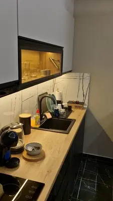 a kitchen with a sink and a counter top at VIRTUS apartmani Vrnjačka Banja centar in Vrnjačka Banja