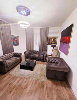 a living room with two couches and a table at Villa Marija Lux in Jagodina