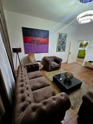 a living room with a couch and a table at Villa Marija Lux in Jagodina