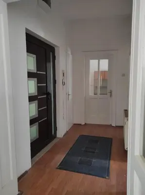 an empty room with a door and a rug at Dona Rooms 3 in Niš