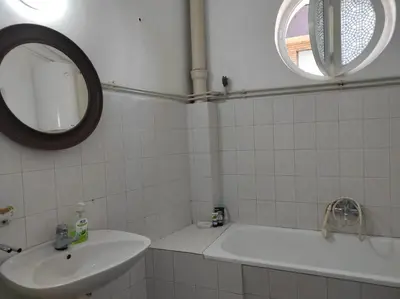 a bathroom with a sink and a tub and a mirror at Dona Rooms 3 in Niš