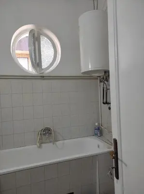 a bathroom with a sink and a window at Dona Rooms 3 in Niš