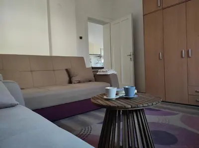 a living room with a couch and a coffee table at Dona Rooms 3 in Niš