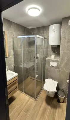 a bathroom with a shower and a toilet and a sink at Ocean Vikend naselje Kopaonik in Kopaonik