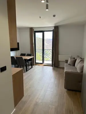a living room with a couch and a table at Ocean Vikend naselje Kopaonik in Kopaonik