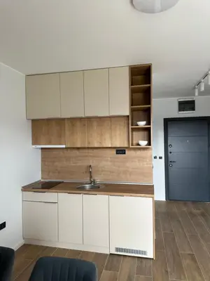 a kitchen with white cabinets and a sink at Ocean Vikend naselje Kopaonik in Kopaonik