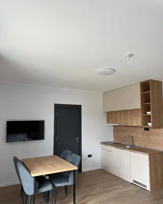 a kitchen with a table and chairs and a sink at Ocean Vikend naselje Kopaonik in Kopaonik