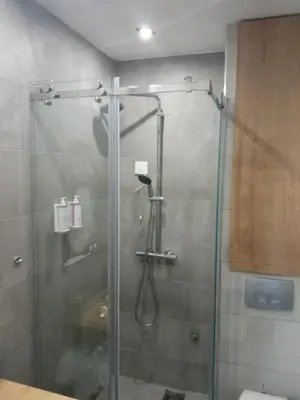a shower in a bathroom with a glass door at Vila Barselona Kopaonik in Raška