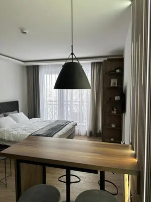 a bedroom with a dining table and a bed at Waves Kopaonik, Residence Hill in Kopaonik
