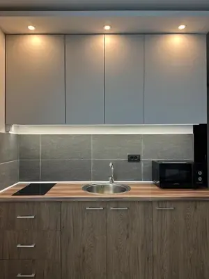 a kitchen with a sink and a microwave at Waves Kopaonik, Residence Hill in Kopaonik