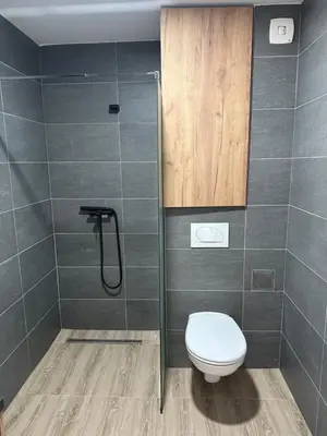a bathroom with a toilet and a shower at Waves Kopaonik, Residence Hill in Kopaonik
