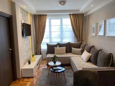 a living room with a couch and a table at LaKop Apartman in Kopaonik