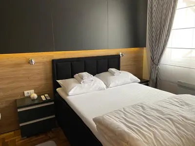 a bedroom with a bed with two white pillows at LaKop Apartman in Kopaonik