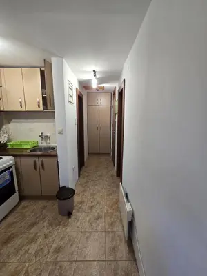 a small kitchen with a hallway leading to a hallway at Apartman Leda in Kopaonik