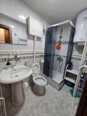 a bathroom with a toilet and a sink and a shower at Apartman Leda in Kopaonik