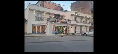 a building on a street with a parking lot at Dina lux apartman 2 in Jagodina