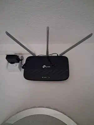 a dvd player hanging from a ceiling above a toilet at Dina lux apartman 2 in Jagodina