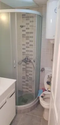 a bathroom with a shower and a toilet in it at Mina in Kopaonik